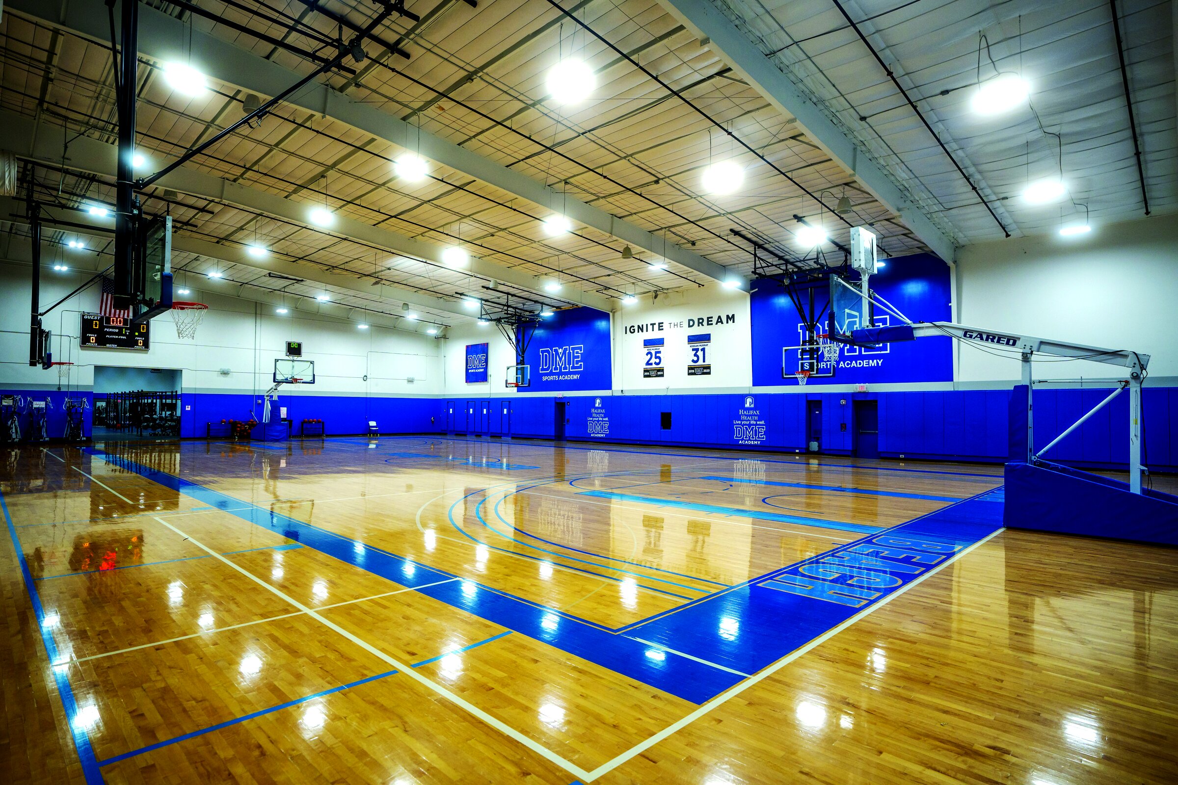 DME Sports Academy basketball court with branded blue walls and professional setup